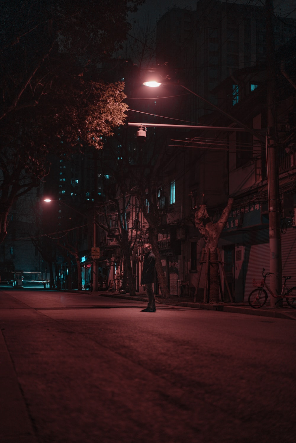 a person standing outside on a dark street