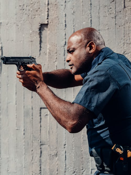 an armed security guard holding a gun in his hands