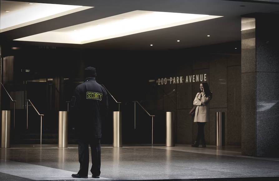 A security guard monitoring a company’s entrance