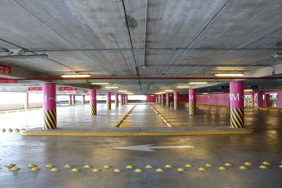 An empty parking lot with direction signage 