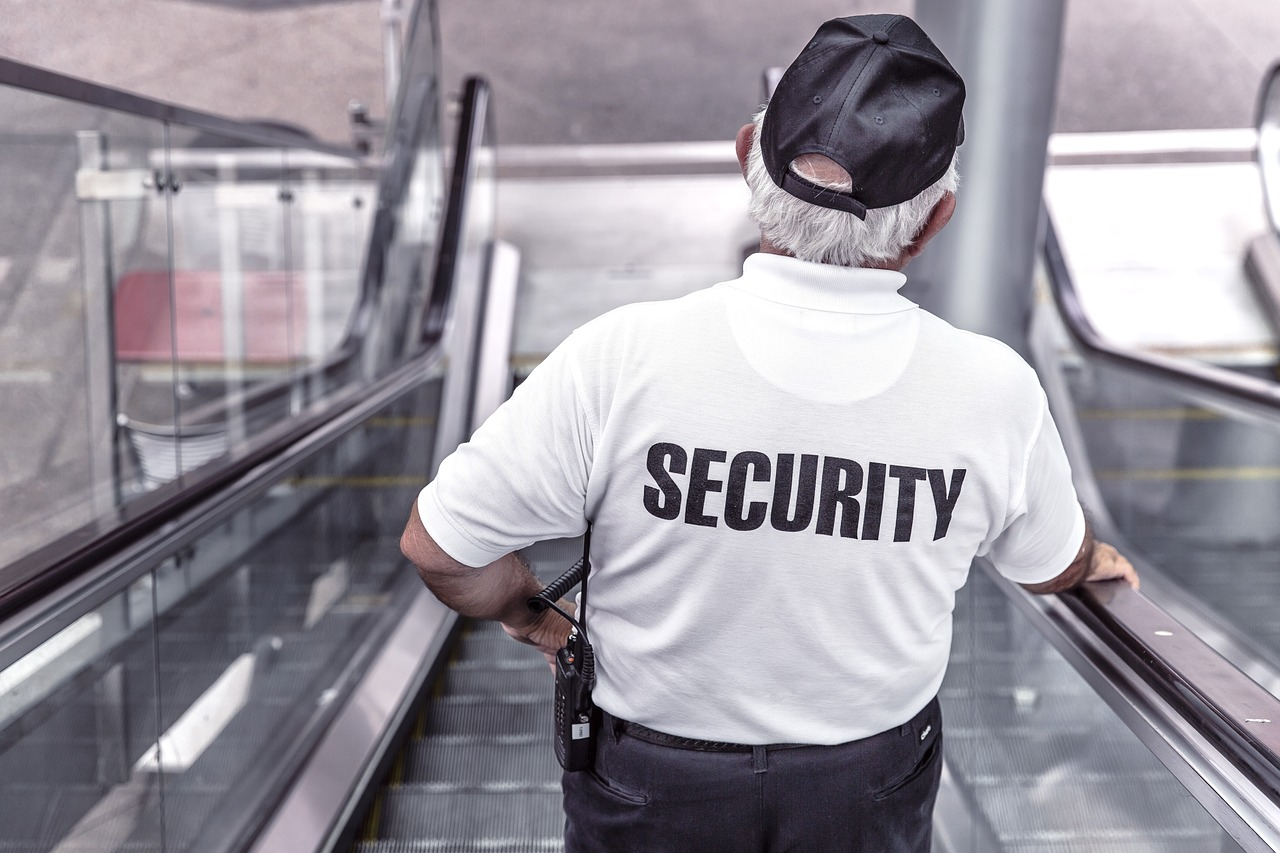 A security guard on an escalator