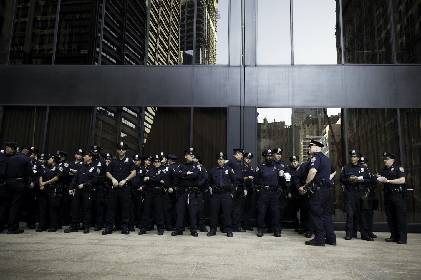 A large group of uniformed security guards outside a building