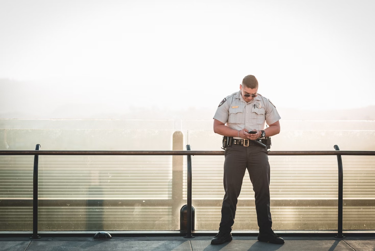 A uniformed security guard on a bridge