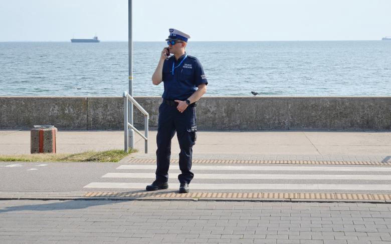 A security guard standing by the coast